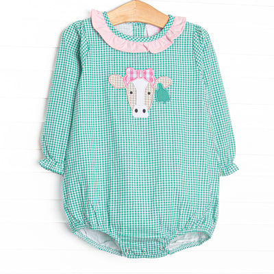 This bubble features mint green gingham, a pink ruffle collar, and a cow applique.