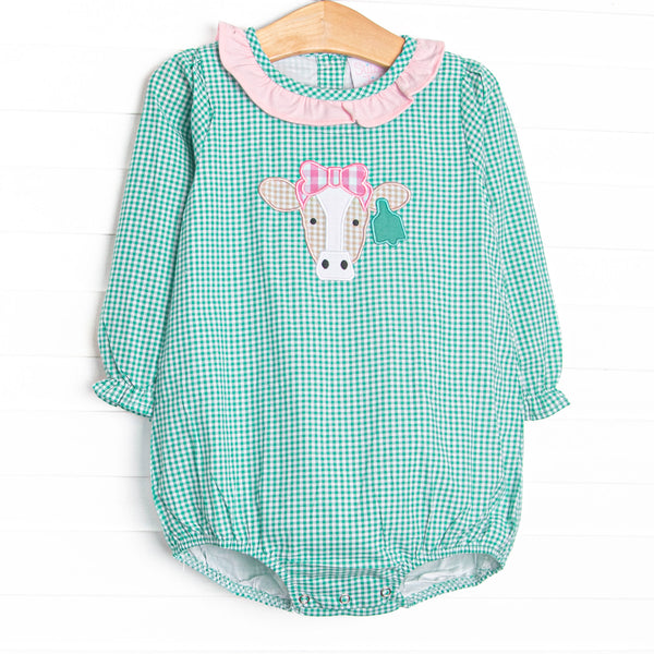 This bubble features mint green gingham, a pink ruffle collar, and a cow applique.