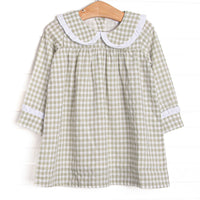  This dress is featured in a green gingham print, with a peter pan collar with a ruffle detail. 