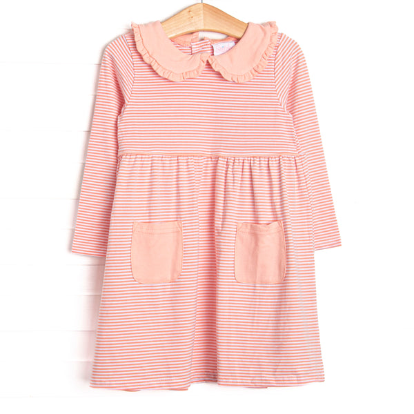 This dress features a peach stripes, front pockets, and a peter pan collar with ruffle trim.