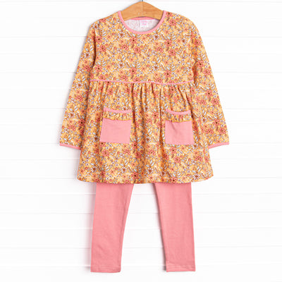 This set features a yellow floral print, pockets to keep little hands warm, and pink leggings to match. 