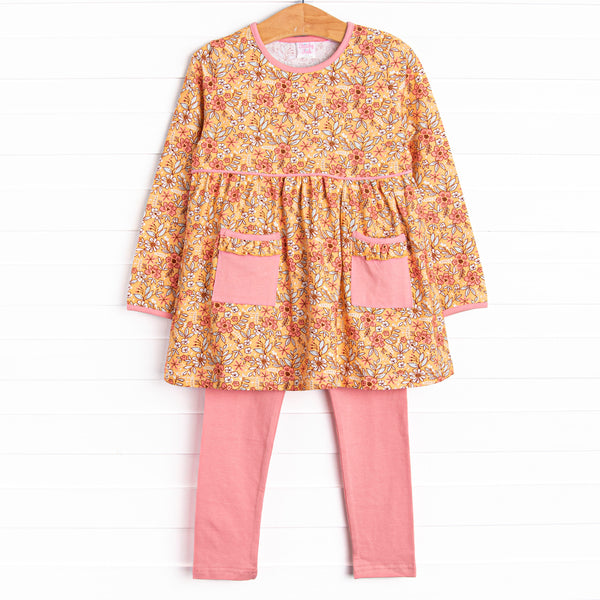 This set features a yellow floral print, pockets to keep little hands warm, and pink leggings to match. 
