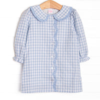 This dress features blue plaid fabric, a ruffle Peter Pan collar, front buttons, and scalloped edges.