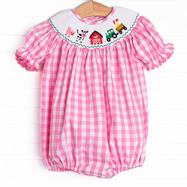  It also features a pink check print, puff sleeves, and a barn smocking. 
