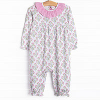  This romper features a pink floral print, pink ruffles and a pink bow on the back. 