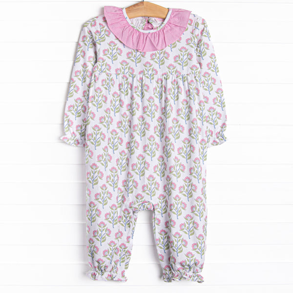  This romper features a pink floral print, pink ruffles and a pink bow on the back. 