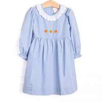 This dress features a blue gingham print, eyelet lace ruffle collar, and pumpkin embroideries.