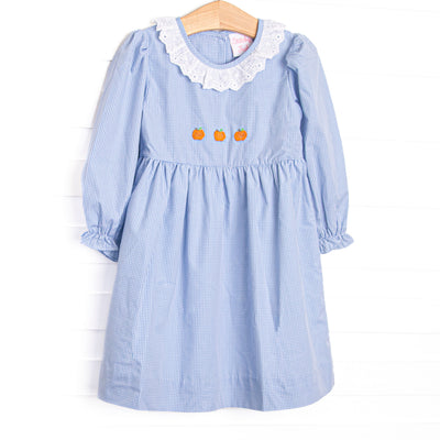 This dress features a blue gingham print, eyelet lace ruffle collar, and pumpkin embroideries.