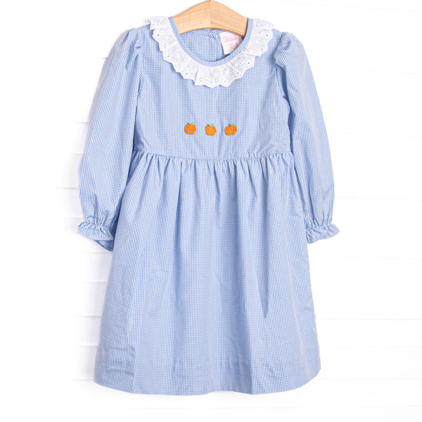 This dress features a blue gingham print, eyelet lace ruffle collar, and pumpkin embroideries.