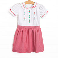  This dress features white fabric, red mini gingham fabric, a white Peter Pan collar, and holly embroidery. 