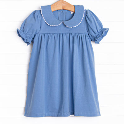 This dress features a blue knit material, puff sleeves, and a peter pan collar.