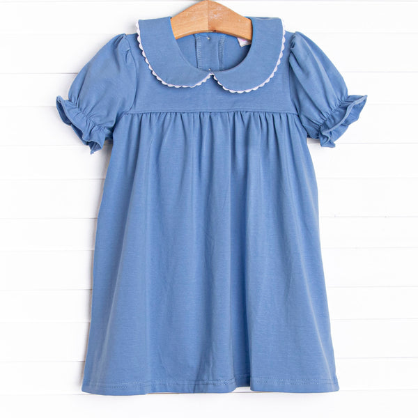 This dress features a blue knit material, puff sleeves, and a peter pan collar.