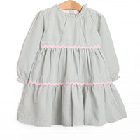  This dress features a sage gingham print, pink ric rac trim, and button closure on the back. 