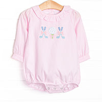 This bubble features pink striped fabric, a ruffle collar, and golf applique.