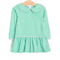  This dress features green fabric, a Peter Pan collar, front buttons, and pink ric rac trim. 