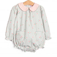  This bubble features green stripes, a pink floral print, a peach Peter Pan collar, and front pockets. 