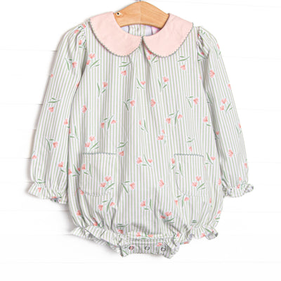  This bubble features green stripes, a pink floral print, a peach Peter Pan collar, and front pockets. 