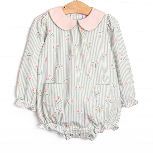  This bubble features green stripes, a pink floral print, a peach Peter Pan collar, and front pockets. 