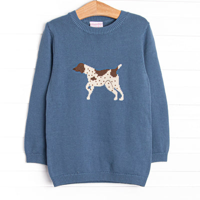 This sweater features a blue material, a rolled neck, and a puppy icon.