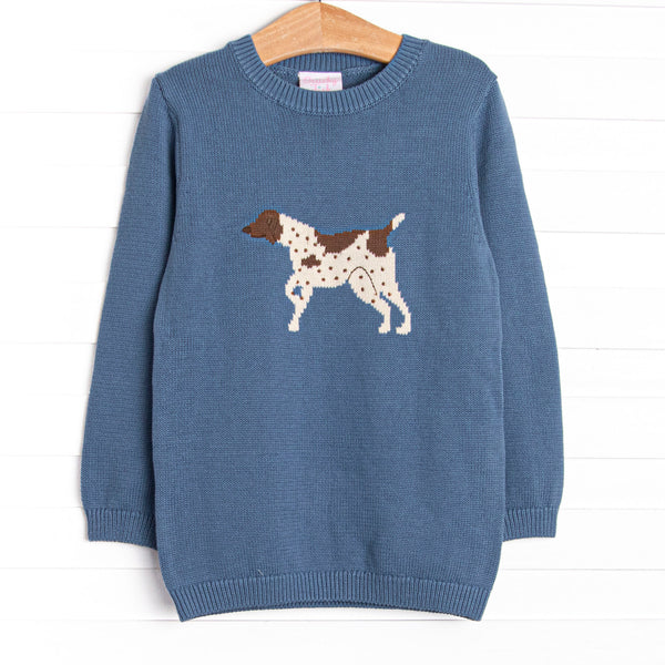 This sweater features a blue material, a rolled neck, and a puppy icon.