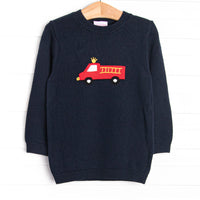 This sweater features a navy&nbsp; material, a rolled neck, and a firetruck icon.