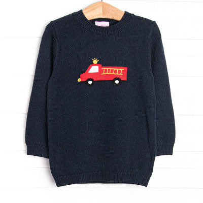 This sweater features a navy&nbsp; material, a rolled neck, and a firetruck icon.