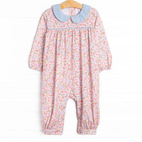  This romper features a pink floral print, a blue peter pan collar, and snaps on the stride. 