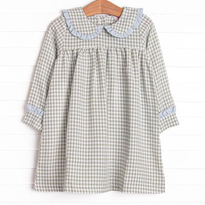 This dress is featured in a green gingham print, with a peter pan collar with a blue ruffle detail.