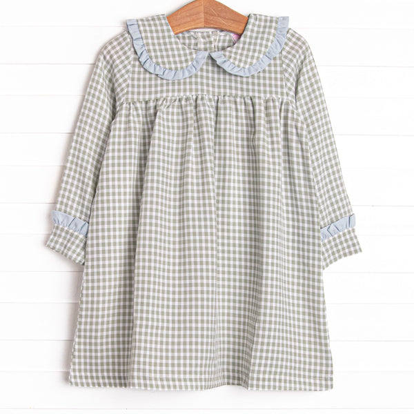 This dress is featured in a green gingham print, with a peter pan collar with a blue ruffle detail.