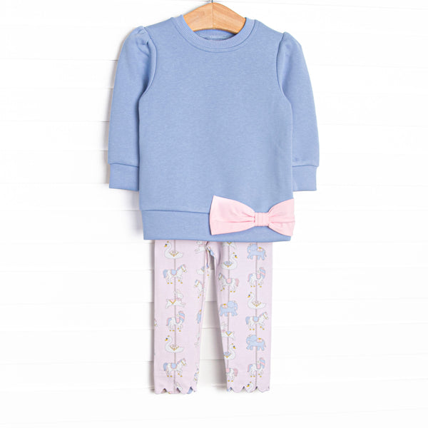  This set features a blue sweatshirt top, a pink bow detail, and pink carousel patterned leggings. 