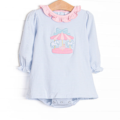 This skirted bubble features blue striped fabric, a pink ruffle collar, and a carousel applique. 