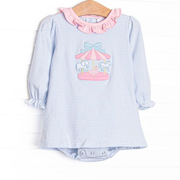 This skirted bubble features blue striped fabric, a pink ruffle collar, and a carousel applique. 