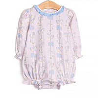  This bubble features pink knit fabric, a carousel pattern, and a blue ruffle collar. 