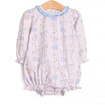 This bubble features pink knit fabric, a carousel pattern, and a blue ruffle collar. 