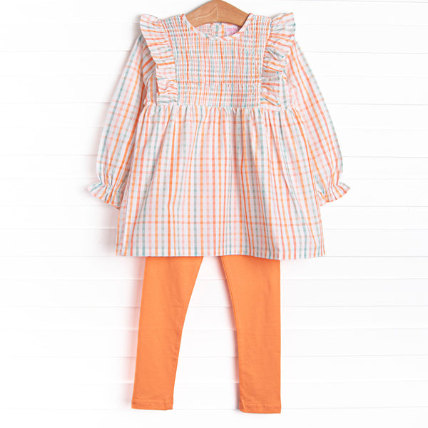  This set features an orange plaid print, ruffle trim, and coordinating orange leggings to match. 