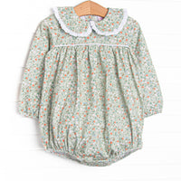 This bubble features a green floral print, a peter pan collar with white ruffle trim, and the softest knit material.