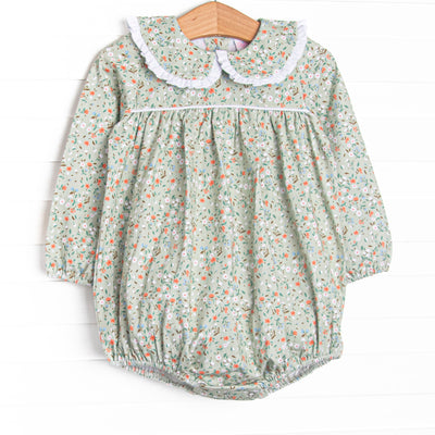This bubble features a green floral print, a peter pan collar with white ruffle trim, and the softest knit material.