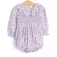 This bubble features purple floral fabric, floral smocking, and a scalloped collar.