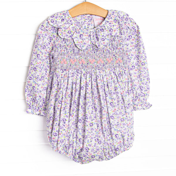This bubble features purple floral fabric, floral smocking, and a scalloped collar.