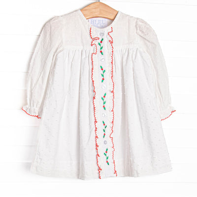  This dress features white Swiss dot fabric, holly embroidery, and red picot trim. 