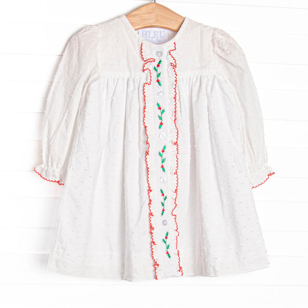  This dress features white Swiss dot fabric, holly embroidery, and red picot trim. 