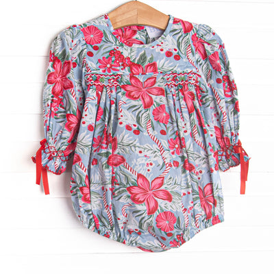  This bubble features a blue floral fabric, dainty smocking, and ribbon sleeve ties. 