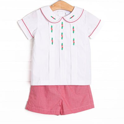  This set features a white top, red mini gingham shorts, a white Peter Pan collar, and holly embroidery. 