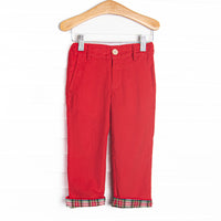 These pants feature a red corduroy fabric, a red and green plaid trim, and belt loop details.