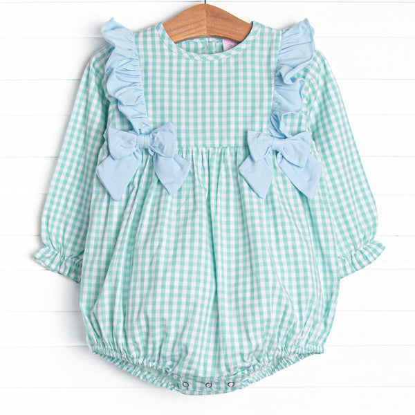  This bubble features a mint green gingham print, snaps on the stride, and blue ruffles and bows. 