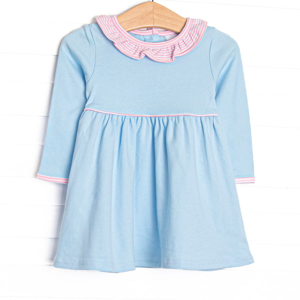 This dress features blue knit material, a pink striped ruffle collar, and pink striped piping. 