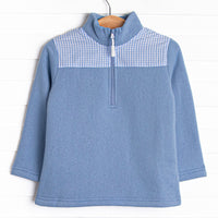  It has gingham on the shoulders, a quarter zip, and the coziest fleece material. 