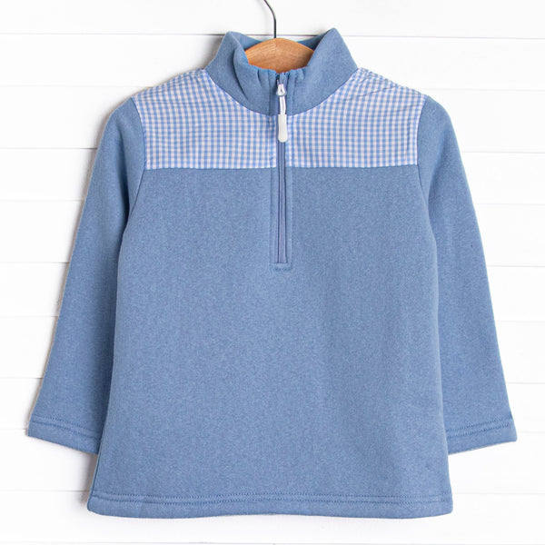  It has gingham on the shoulders, a quarter zip, and the coziest fleece material. 