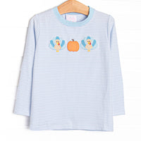 This top features light blue striped knit fabric, pumpkin and turkey applique, and long sleeves.