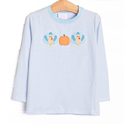 This top features light blue striped knit fabric, pumpkin and turkey applique, and long sleeves.